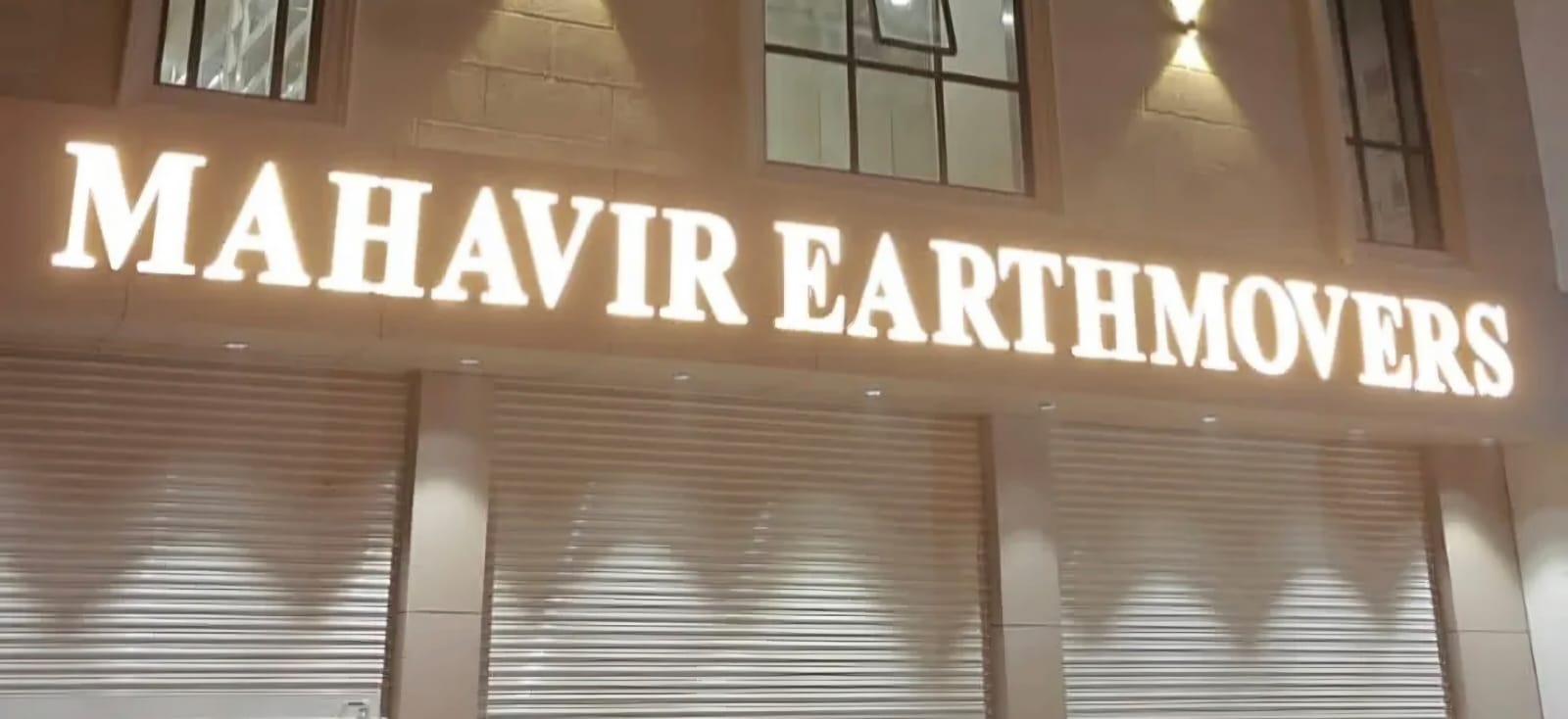 Clothing showroom with backlit white letters on black ACP